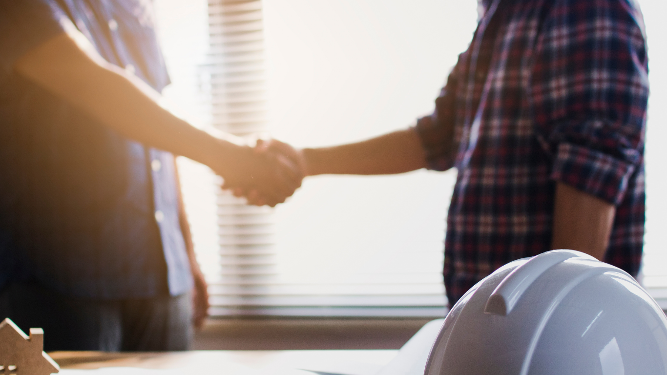 a home contractor shaking hands with a homeowner